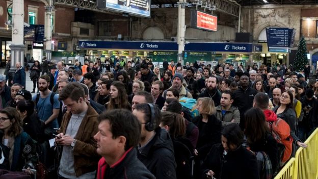 Passengers waiting for a delayed service at London Victoria during a strike day on 13 December