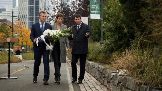 Argentinian President Mauricio Macri and First Lady of Argentina Juliana Awada carry flowers as they attend a tribute for the victims of last week's vehicular attack, November 6, 2017 in New York City.