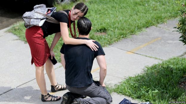 Woman comforting Gideon Hodge