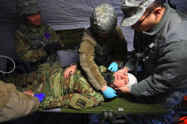 US soldiers give first aid to a mock victim in a tent during a joint medical evacuation exercise as part of the annual massive military exercises, known as Key Resolve and Foal Eagle, at a South Korean Army hospital in Goyang, northwest of Seoul, on 15 March 2017.