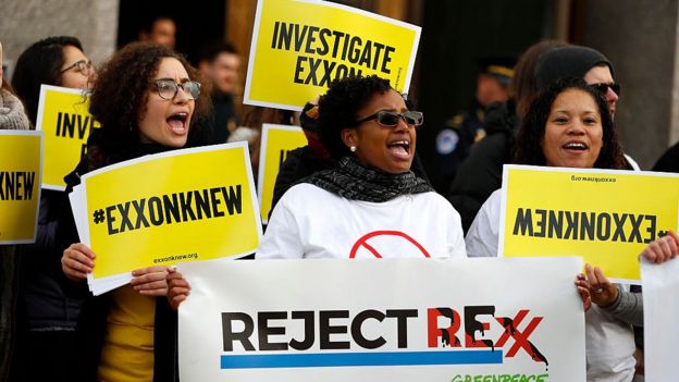 Protesters with #exxonknew signs