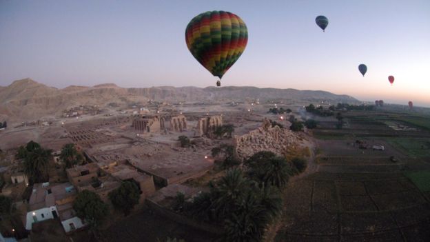 Hot air balloons carry tourists over Egypt's Valley of the Kings, near Luxor, 15 November 2007