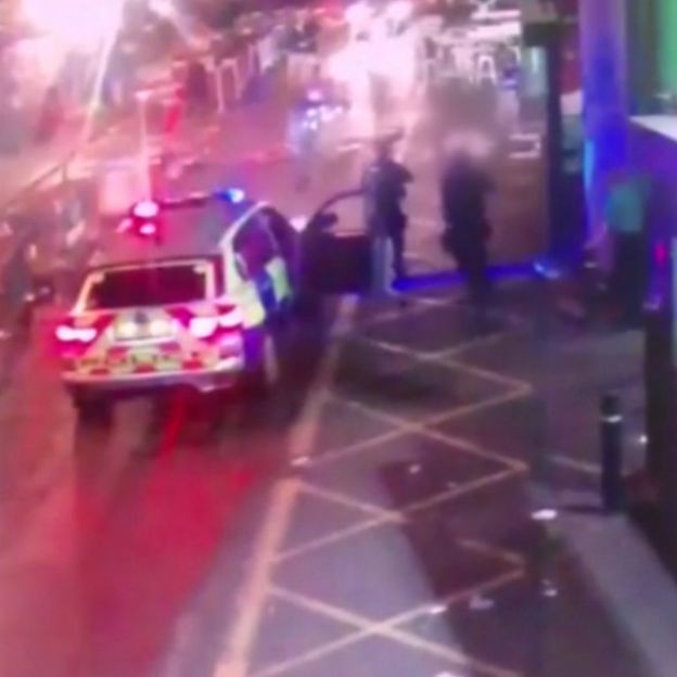 Police point rifles at the three men
