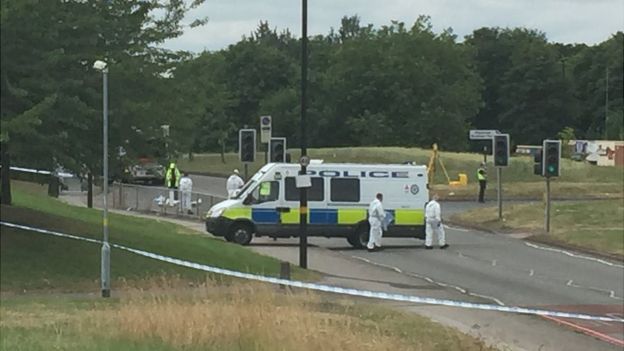 Police officers at the scene of the crash