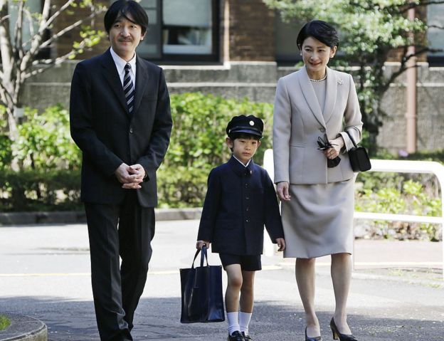 Prince Hisahito (C) accompanied by his parents Prince Akishino (L) and Princess Kiko, arrive at Ochanomizu University Elementary School for his entrance ceremony in Tokyo on 7 April 2013