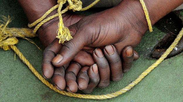 A suspected Somali pirate's hands are tied behind his back during a media interaction on board an Indian Coast guard ship off the coast of Mumbai on February 10, 2011