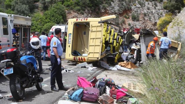 Medics and rescue workers stand at the scene after a tourist bus crashed near the southwestern holiday town of Marmaris