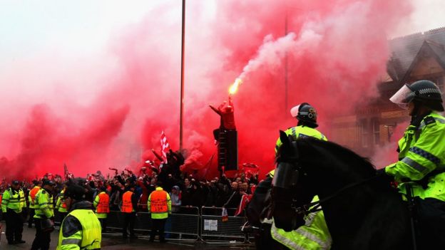 Liverpool fans using flares outside Anfield 