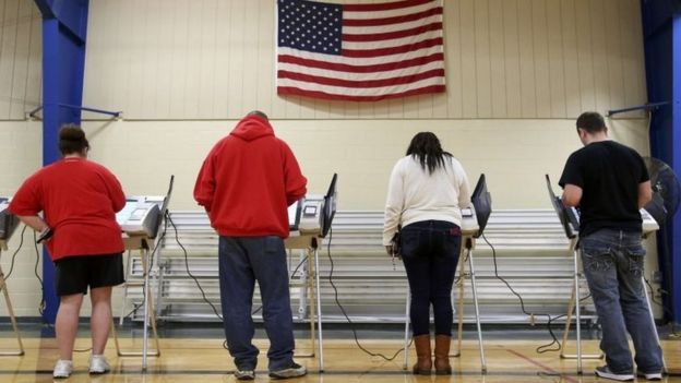 Voters cast their votes during the US presidential election in Elyria, Ohio, on 8 November.