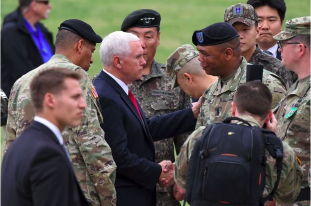 US Vice President Mike Pence (centre L) shakes hands with US military officers upon his arrival at army base Camp Bonifas in Paju near the truce village of Panmunjom during a visit to the Demilitarized Zone (DMZ) on the border between North and South Korea on 17 April 2017.