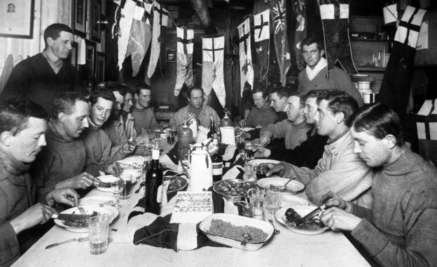 Captain Robert Falcon Scott (seated centre, back) and members of his ill-fated expedition to Antarctica enjoying his last birthday party.