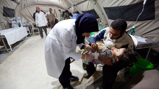 An Iranian child receives medical at a temporary hospital in the city of Pole-Zahab in Kermanshah Province, Iran, 13 November 2017.
