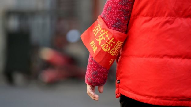 A close up shot of a Beijing resident's red armband, identifying her as security volunteer, in Beijing, China, 2 March 2017.