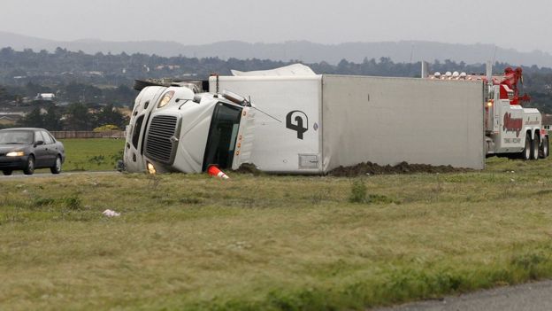 A lorry lies on its side after it was blown over by strong winds in Marina, California, on 17 February 2017