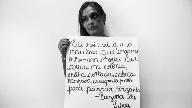 Mulher segurança placa com letra de música de Bezerra da Silva