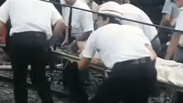 Rescuers haul a survivor from the wreckage