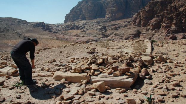 An archaeologist inspects ruins in Petra