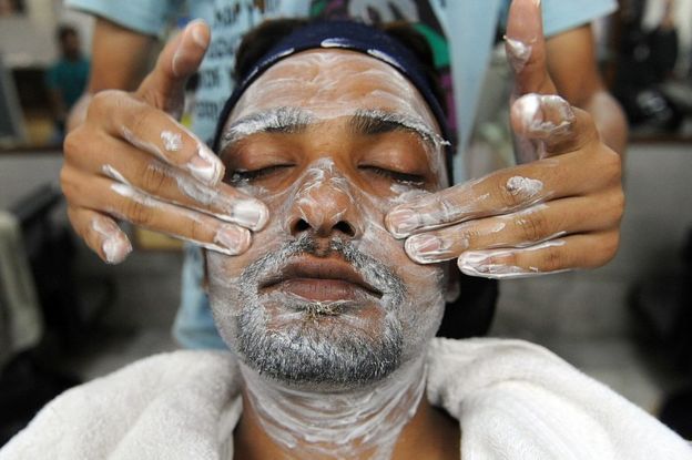 Un hombre al que le está siendo aplicado un cosmético.