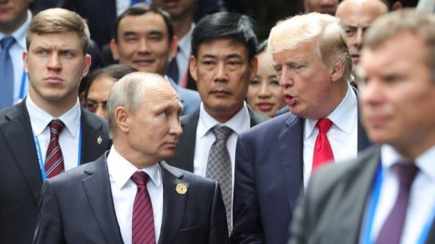 Russian President Vladimir Putin chats to Donald Trump at Apec summit on 11 November