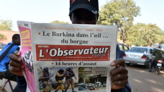 A man reads a newspaper in the streets of Ouagadougou, following the jihadist attack claimed by Al-Qaeda in the Islamic Maghreb.