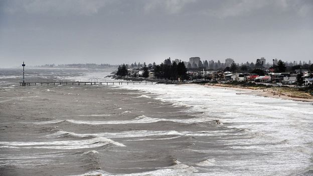 The aftermath of a storm creates choppy waves on a beach in South Australia after last year's blackouts