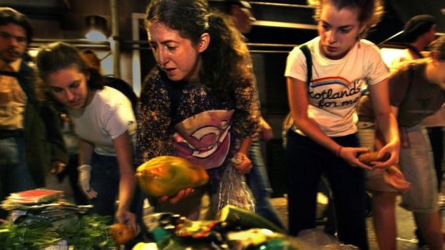 Personas recogiendo alimentos de entre la basura