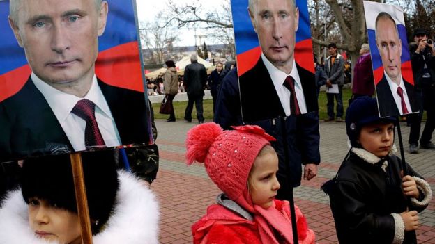 Niños con letreros de Putin