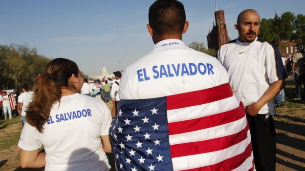 A protester wearing T-shirt that reads El Salvador and with a US flag draped over his shoulders during an immigration rally on the National Mall 10 April 2006 in Washington