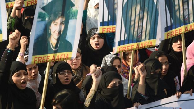 Pakistani protesters carry portraits of Aafia Siddiqui, a Pakistani scientist who is currently serving a prison term in the US, in Pakistan, 2008