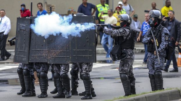 Police try to unblock a street in Rio de Janeiro