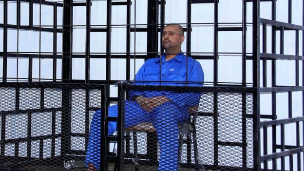 Saif al-Islam Gaddafi, son of late Libyan leader Muammar Gaddafi, attends a hearing behind bars in a courtroom in Zintan, 25 May 2014
