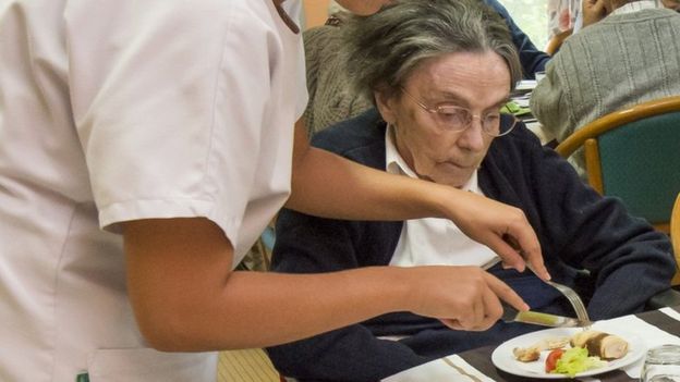 Cutting up lunch for an elderly person