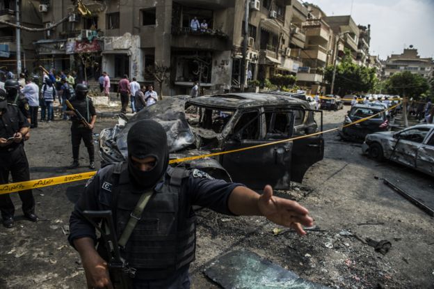 Egyptian security forces stand guard at the site of a bomb attack that targeted the convoy of Egyptian state prosecutor, Hisham Barakat, who died hours after the powerful explosion hit his convoy, in the capital Cairo on June 29, 2015.