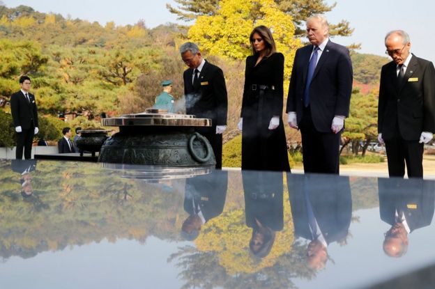 US President Donald Trump and first lady Melania attend a wreath-laying ceremony at the National Cemetery in Seoul, South Korea, 8 November 2017.
