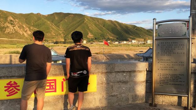 People look across to North Korea from Tumen, China. 30 Aug 2017