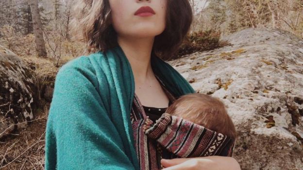 Aliya Shagieva with her baby against the backdrop of Kyrgyz landscape