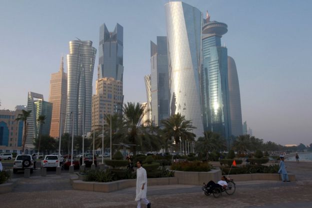 A man walks on the corniche in Doha, Qatar, 15 June