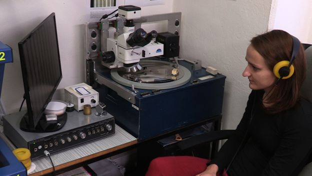 A member of GZ staff listening to a record