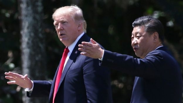 U.S. President Donald Trump (L) and China's President Xi Jinping walk along the front patio of the Mar-a-Lago estate after a bilateral meeting in Palm Beach, Florida, U.S., April 7, 2017.