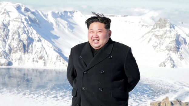 North Korean leader Kim Jong-un smiles on top of a snowy Mount Paektu