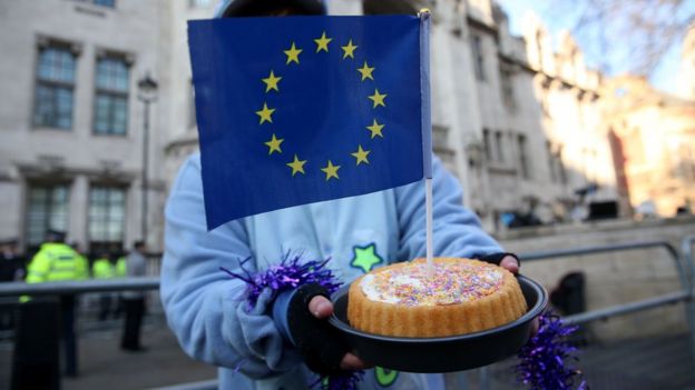 Женщина с пирогом, в который воткнут флаг ЕС
