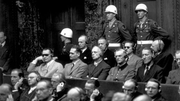 Some of the chief defendants listening to the court summary at the Nuremberg War Trials. In the front row (from left to right) are Goering, Hess, von Ribbentrop, Keitel, Kaltenbrunner and Rosenberg. In the back row are Doenitz, Raeder, von Schirach and Sauckel