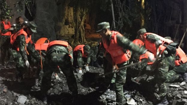 Paramilitary police dig in the rubble in Jiuzhaigou