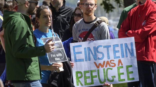 People holding placards during the March for Science day at the Jardin Anglais in Geneva, Switzerland, 22 April 2017