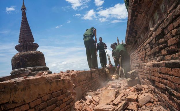 Military personnel clear debris at a temple that was damaged by a strong earthquake in Bagan, Myanmar, 25 August 2016.