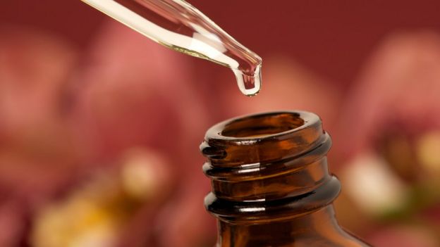 Essential oil dripping in bottle