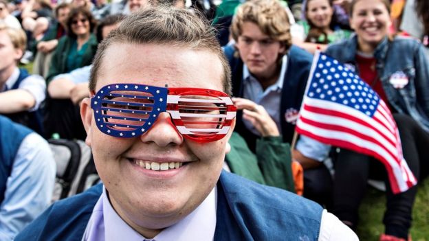 A man in American flag glasses attends an Independence Day celebration in Rebild National Park in Rebild, Denmark July 4, 2017