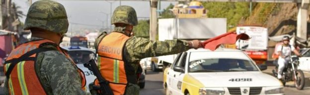 Soldiers from the Mexican Army stop drivers at a checkpoint on the Acapulco-Mexico City highway on December 5, 2017 in Acapulco, Guerrero state, Mexico.