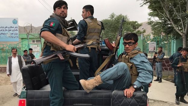 Afghan policemen arrive at the site of blasts in Kabul, Afghanistan