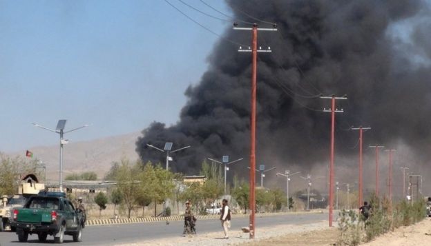 Smoke rises from police headquarters while Afghan security forces keep watch after a suicide car bomber and gunmen attacked the provincial police headquarters in Gardez, the capital of Paktia province, Afghanistan, on 17 October, 2017.